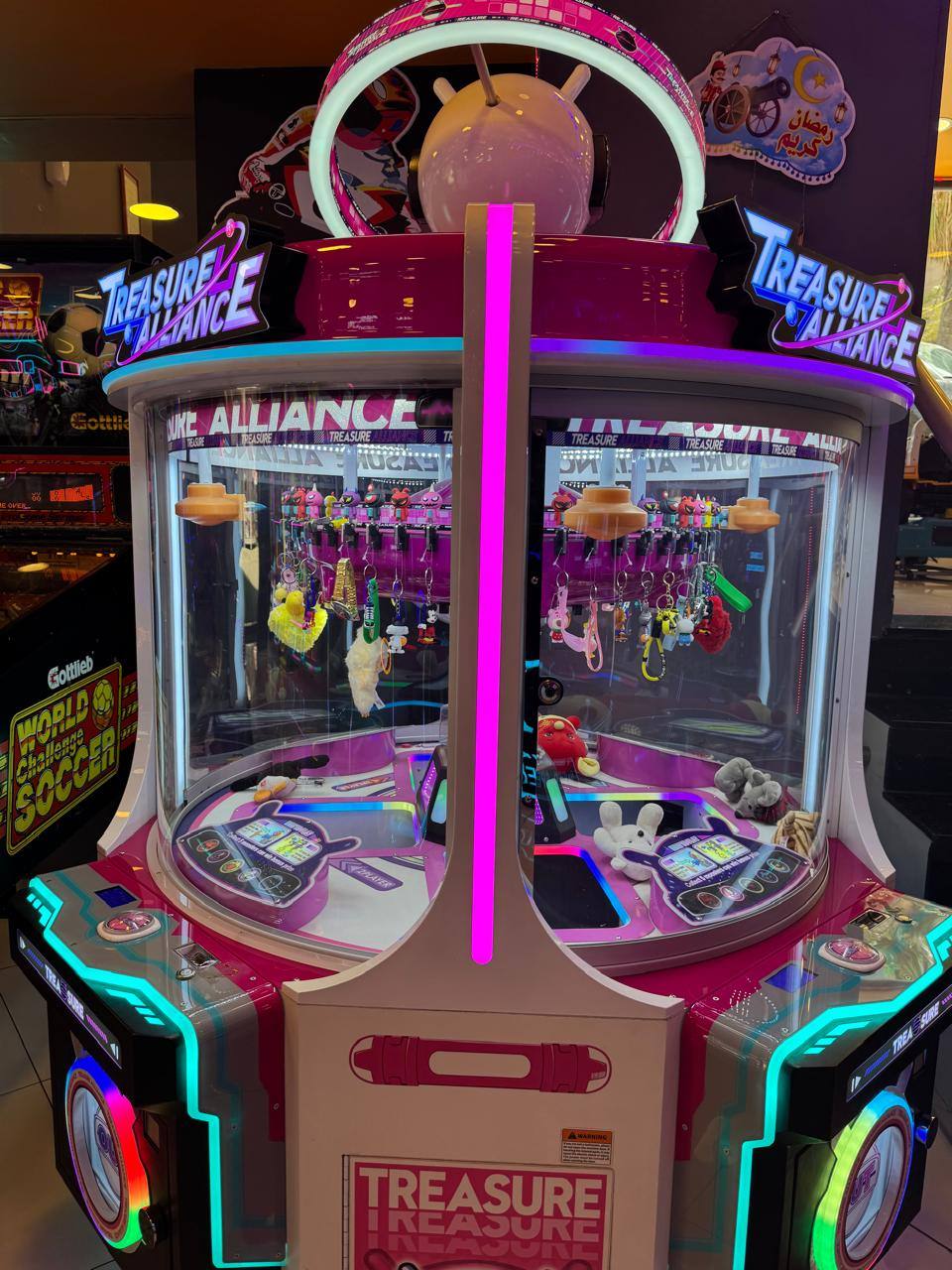 Treasure Alliance neon pink claw machine with plush prizes